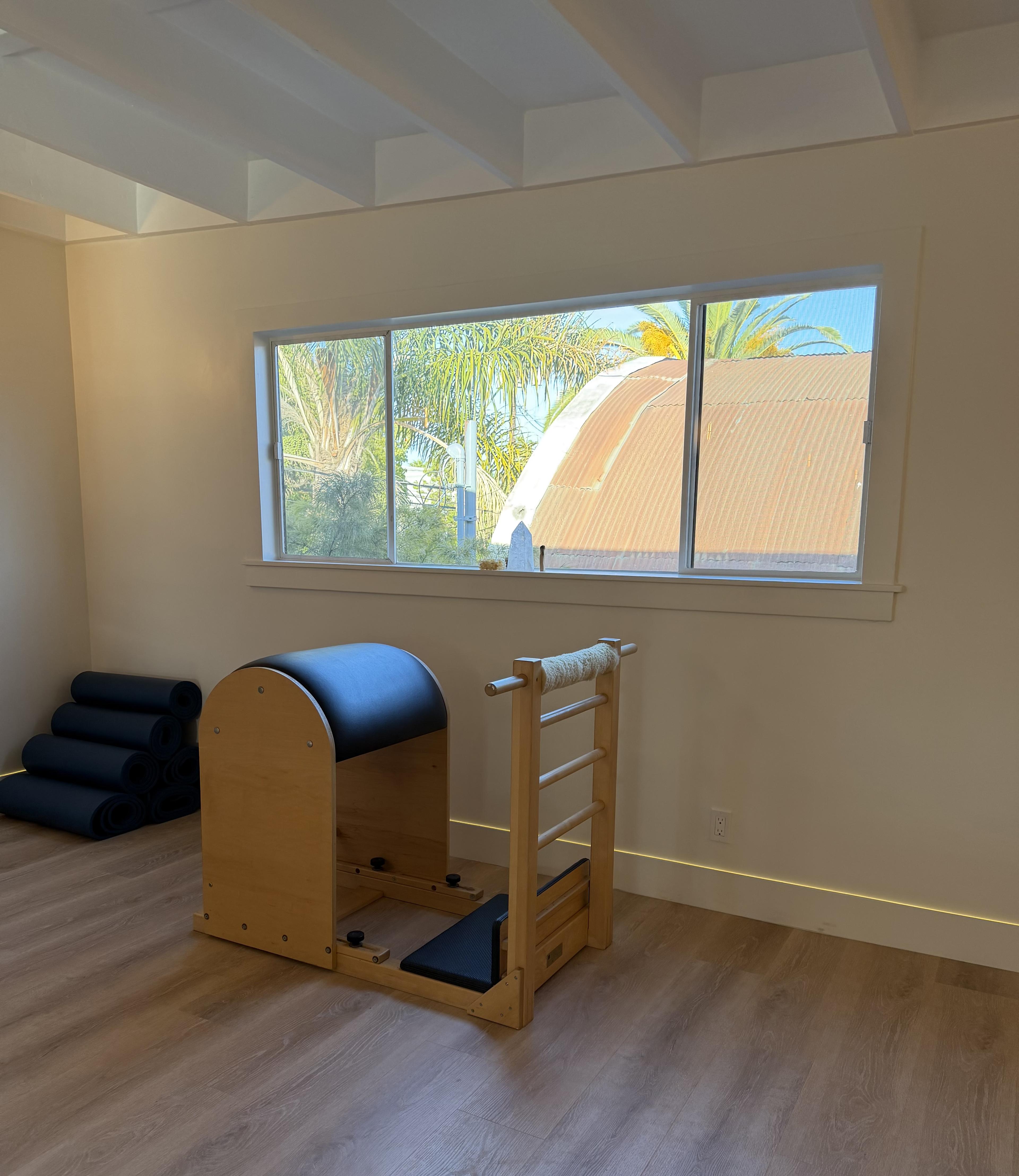 The studio interior — a ladder barrel by the window, with the Funk Zone outside